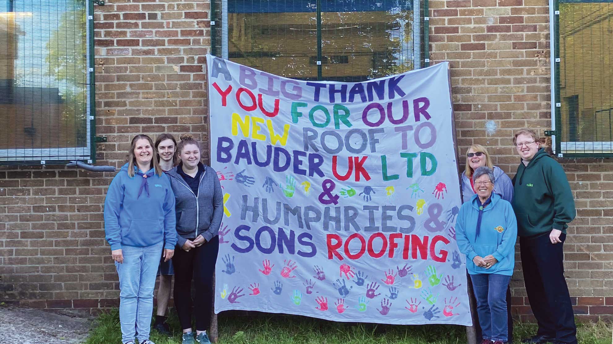 A group of people holding up a thank you banner