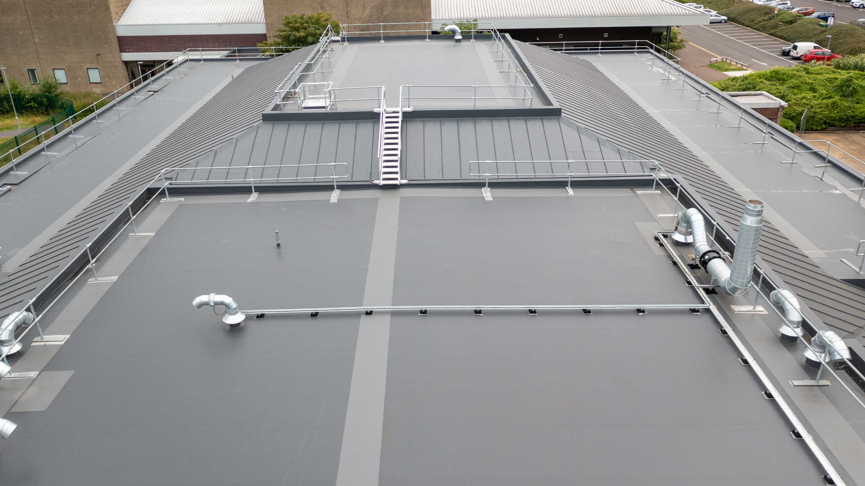 BauderThermofol PVC single ply system with profiled infill overlay system shown on University of West England W Block