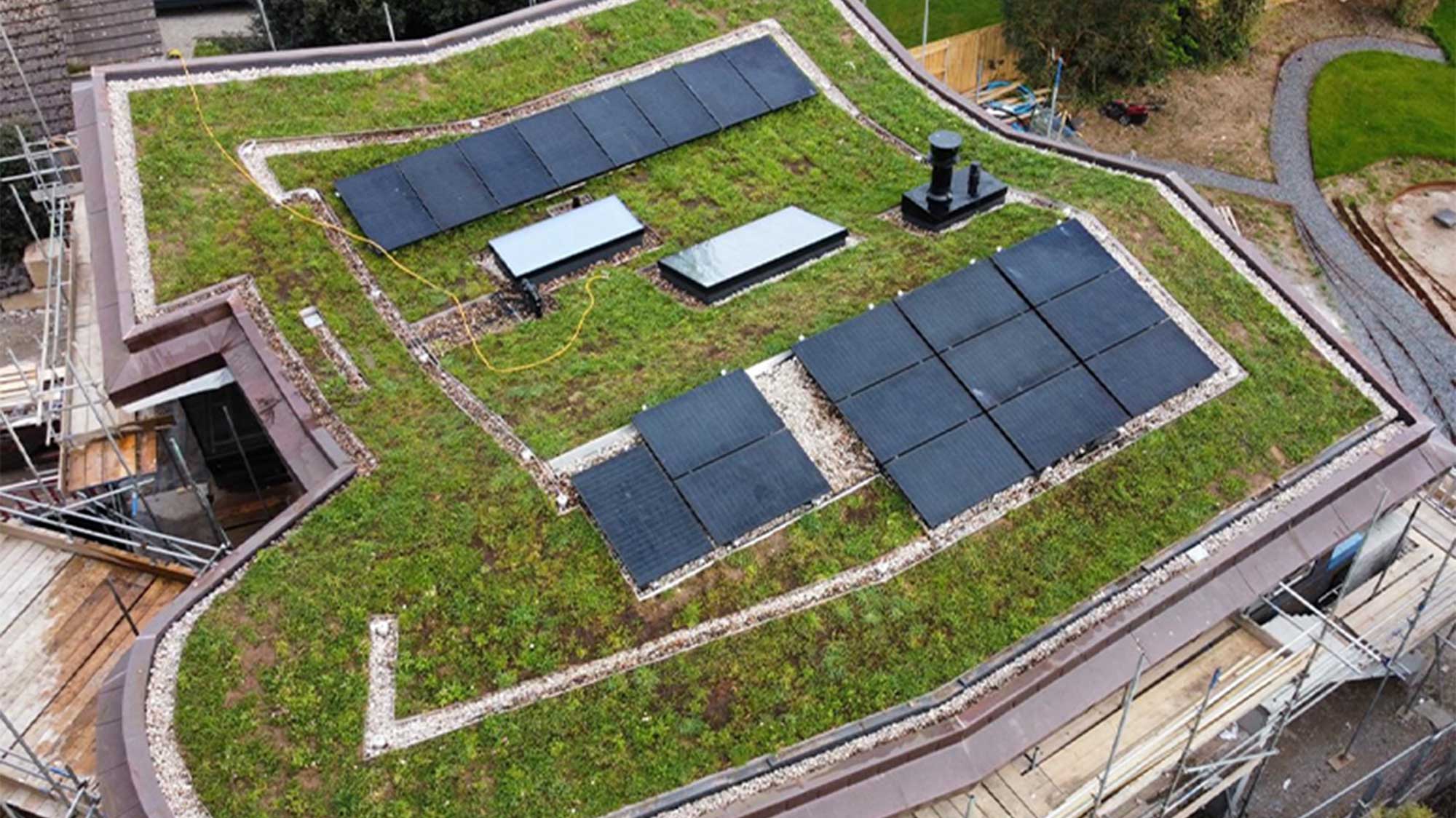 Completed green roof of modern building with solar panels under construction