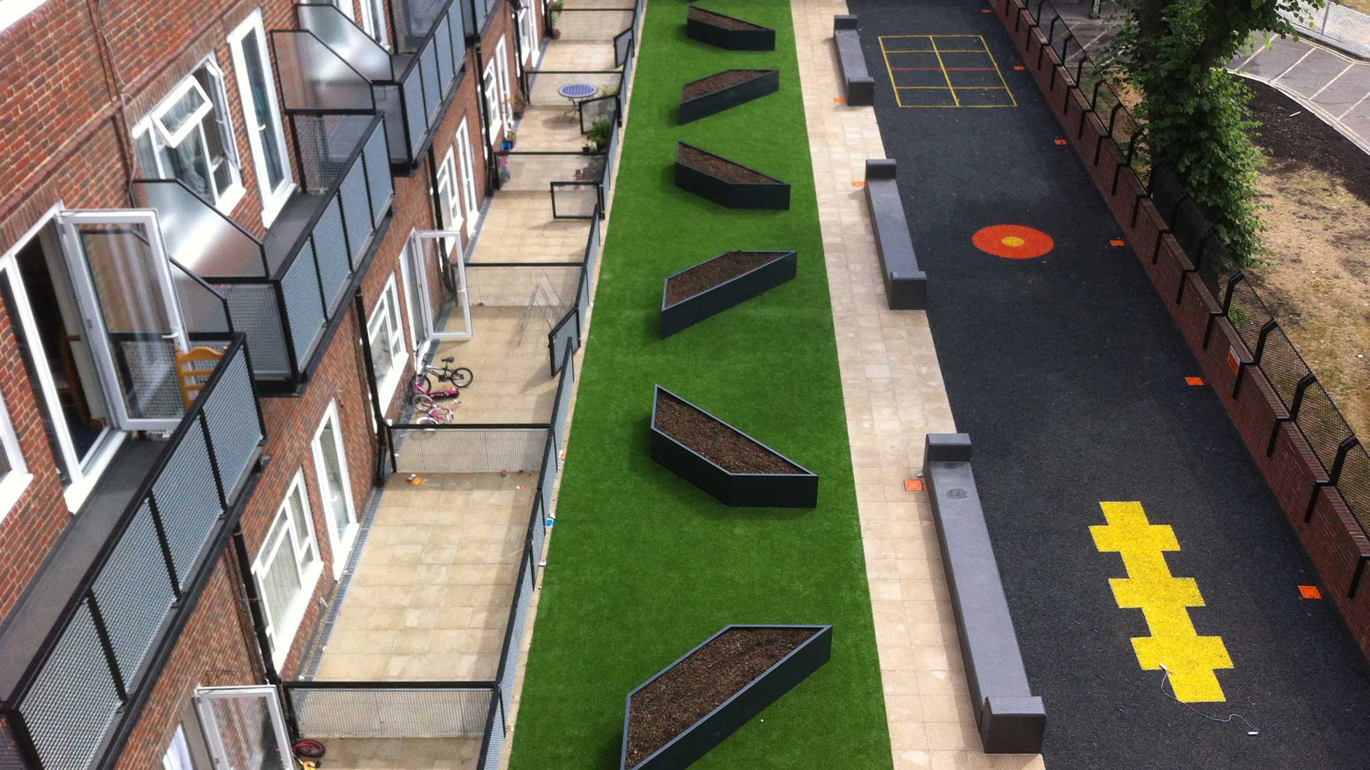 Permeable paving on the ground floor patios and walkways, artificial turf featuring fibreglass planters