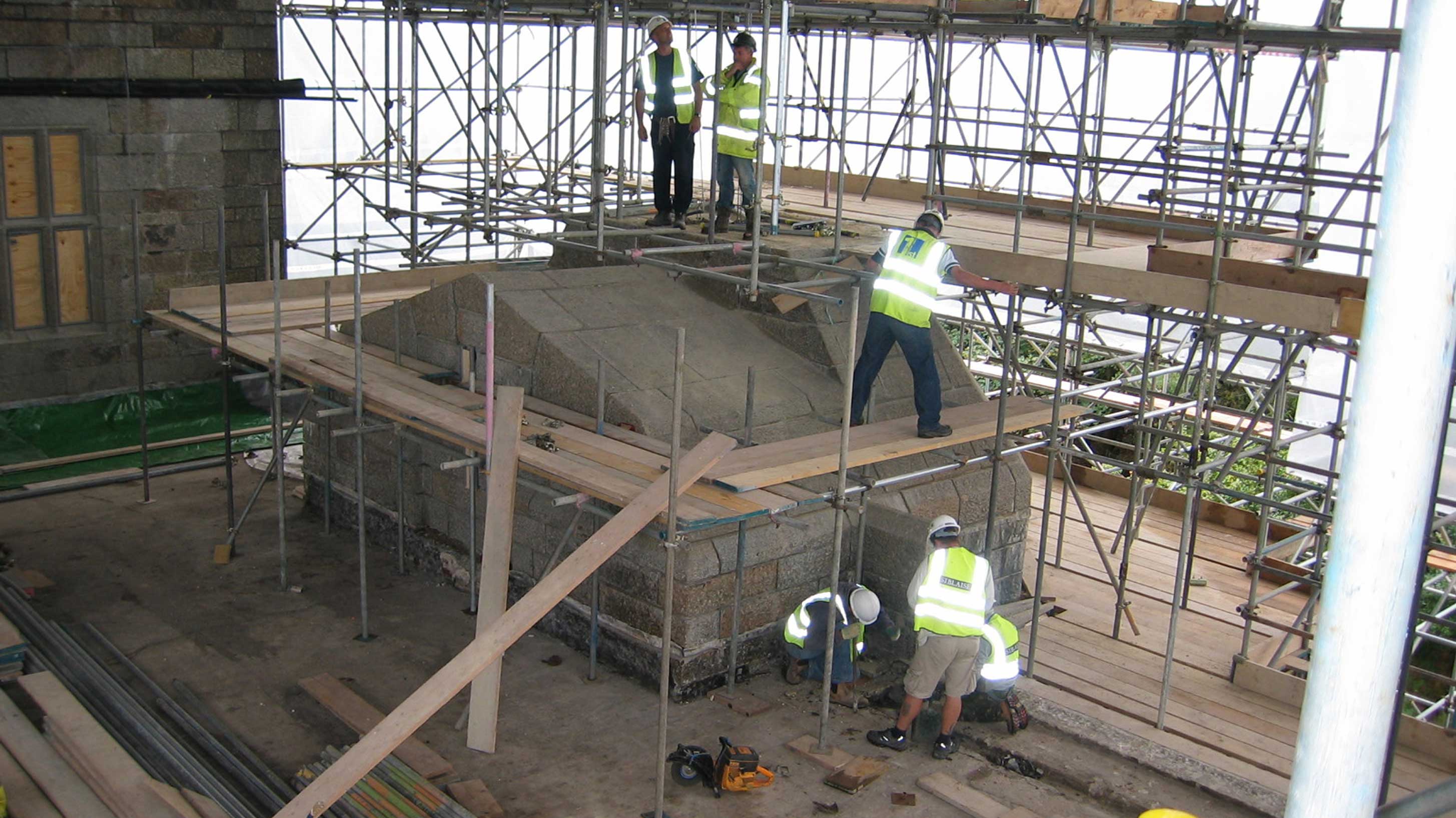 Scaffolding setup with men standing in Castle Drogo