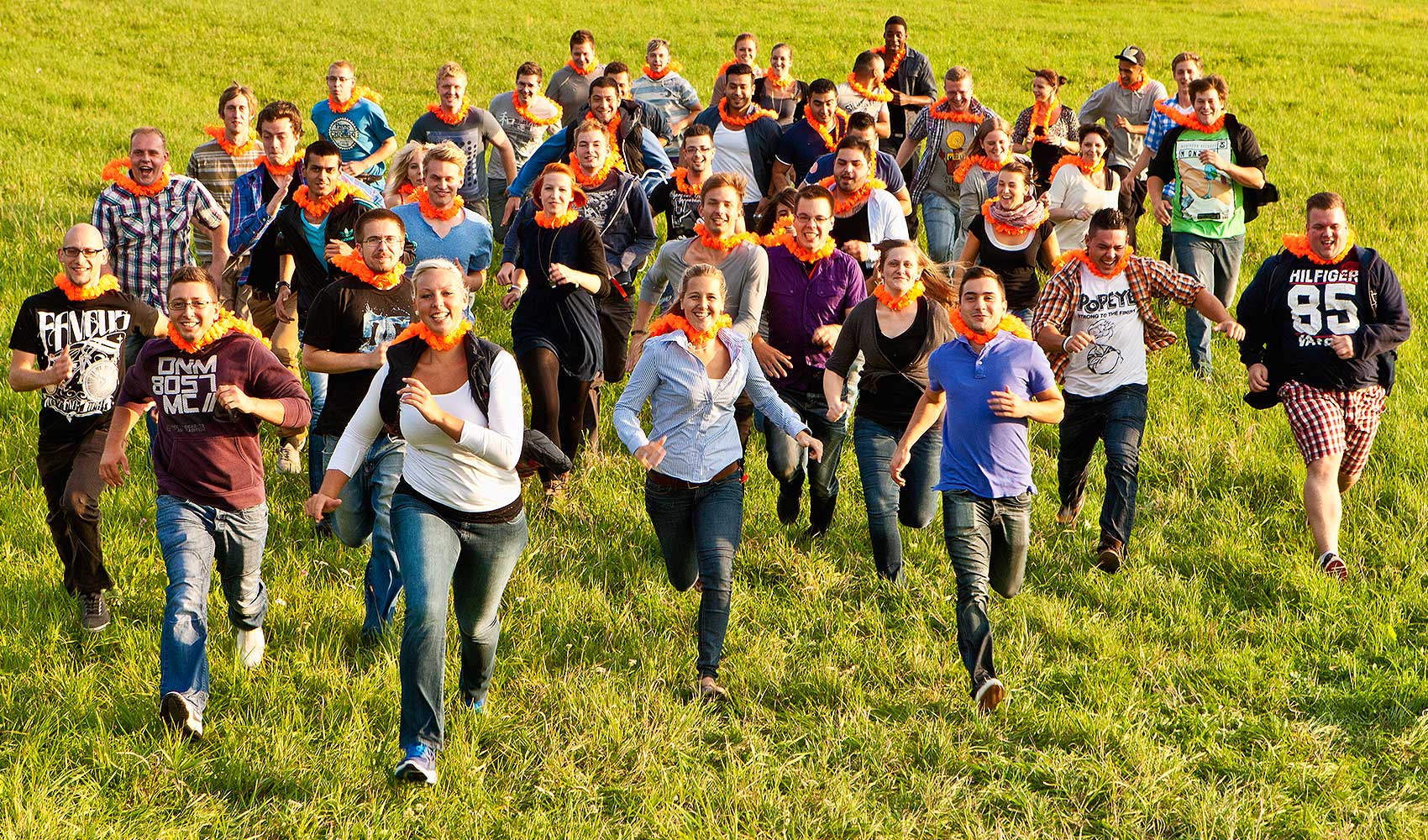 Bauder team in orange scarfs running together