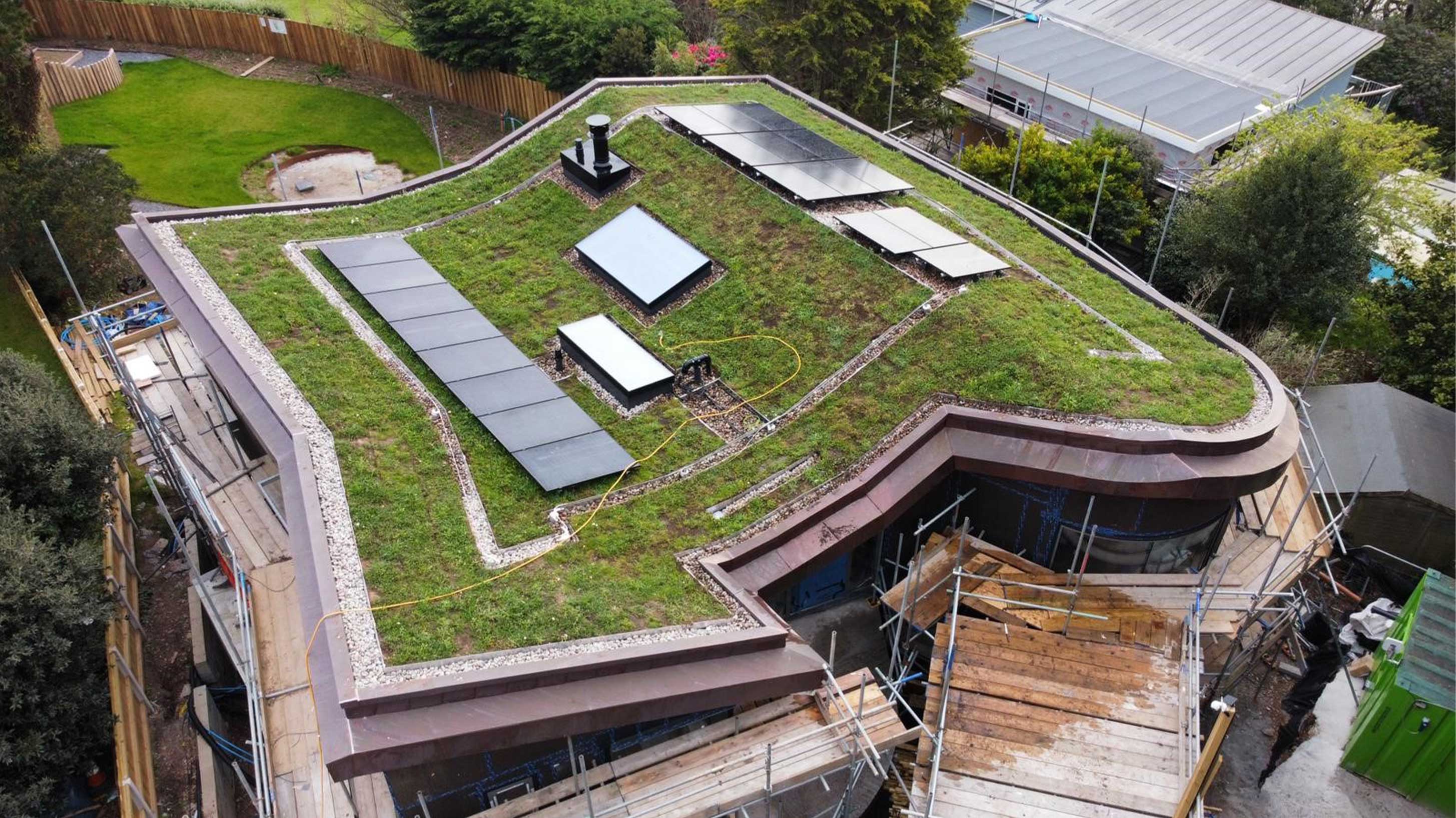 Completed green roof of modern building with solar panels under construction