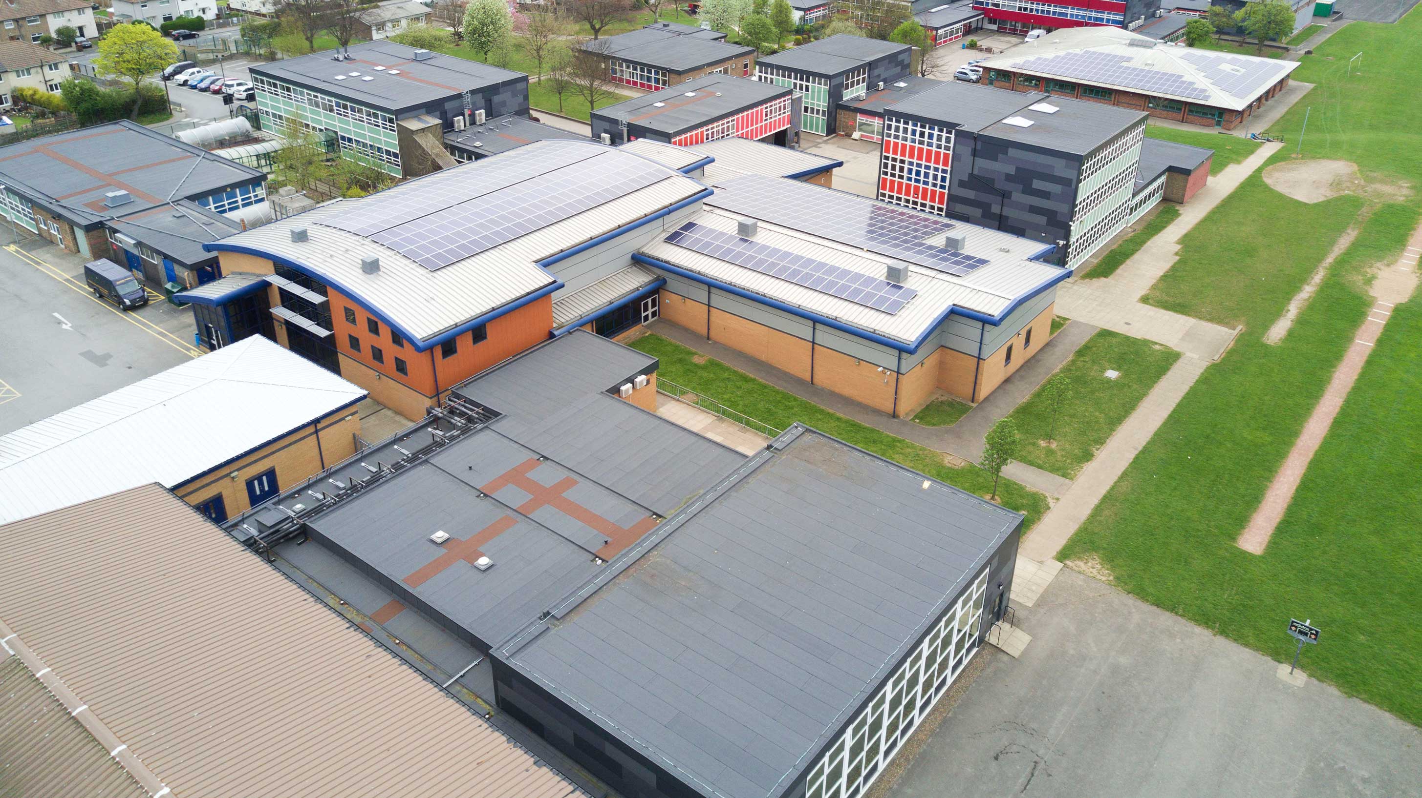 Aerial view of Airedale Academy showing Bauder Total Roof System with rooflights and array of solar panels