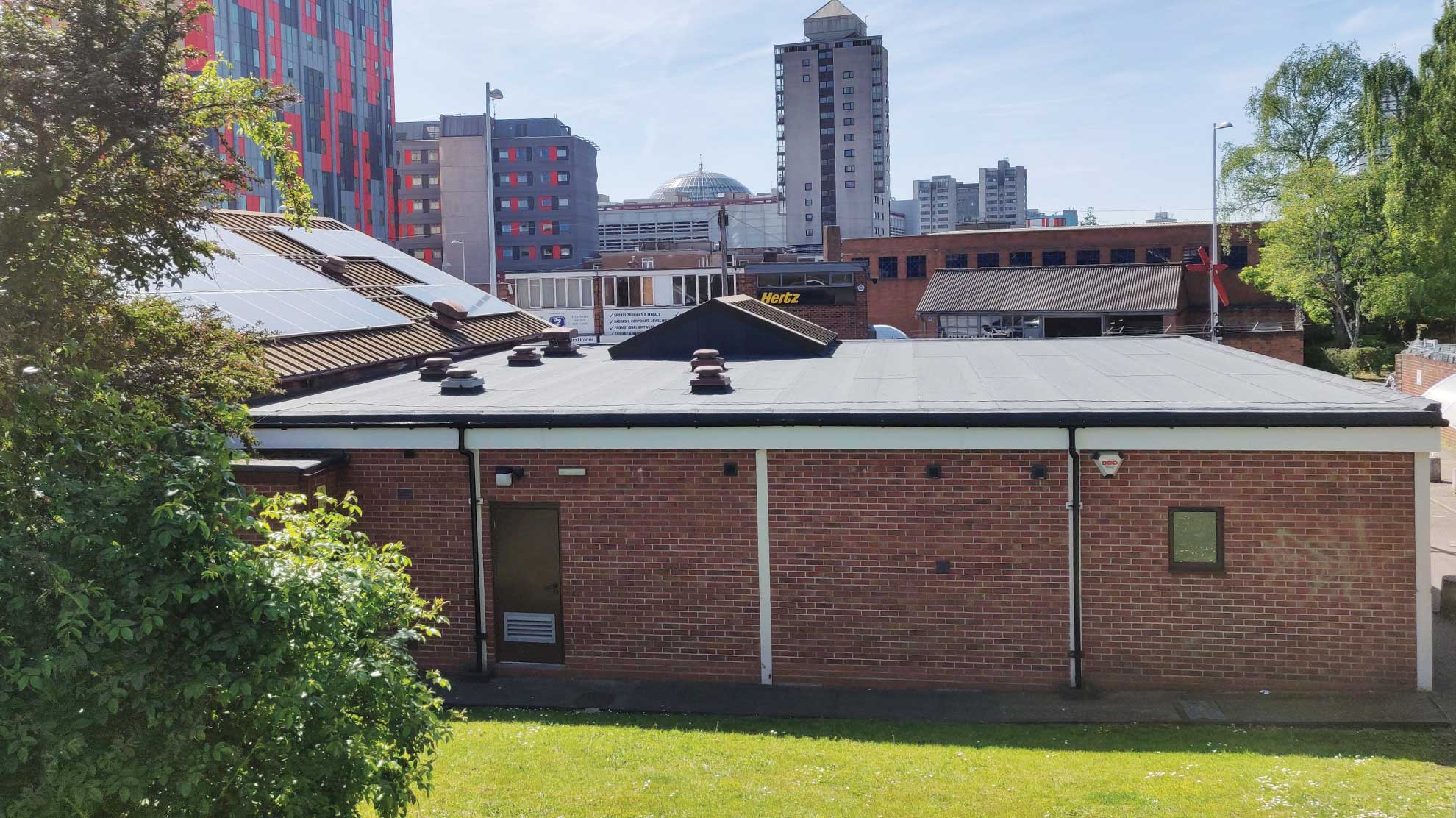 Back of Jesus Centre charity building with waterproofing rooftop
