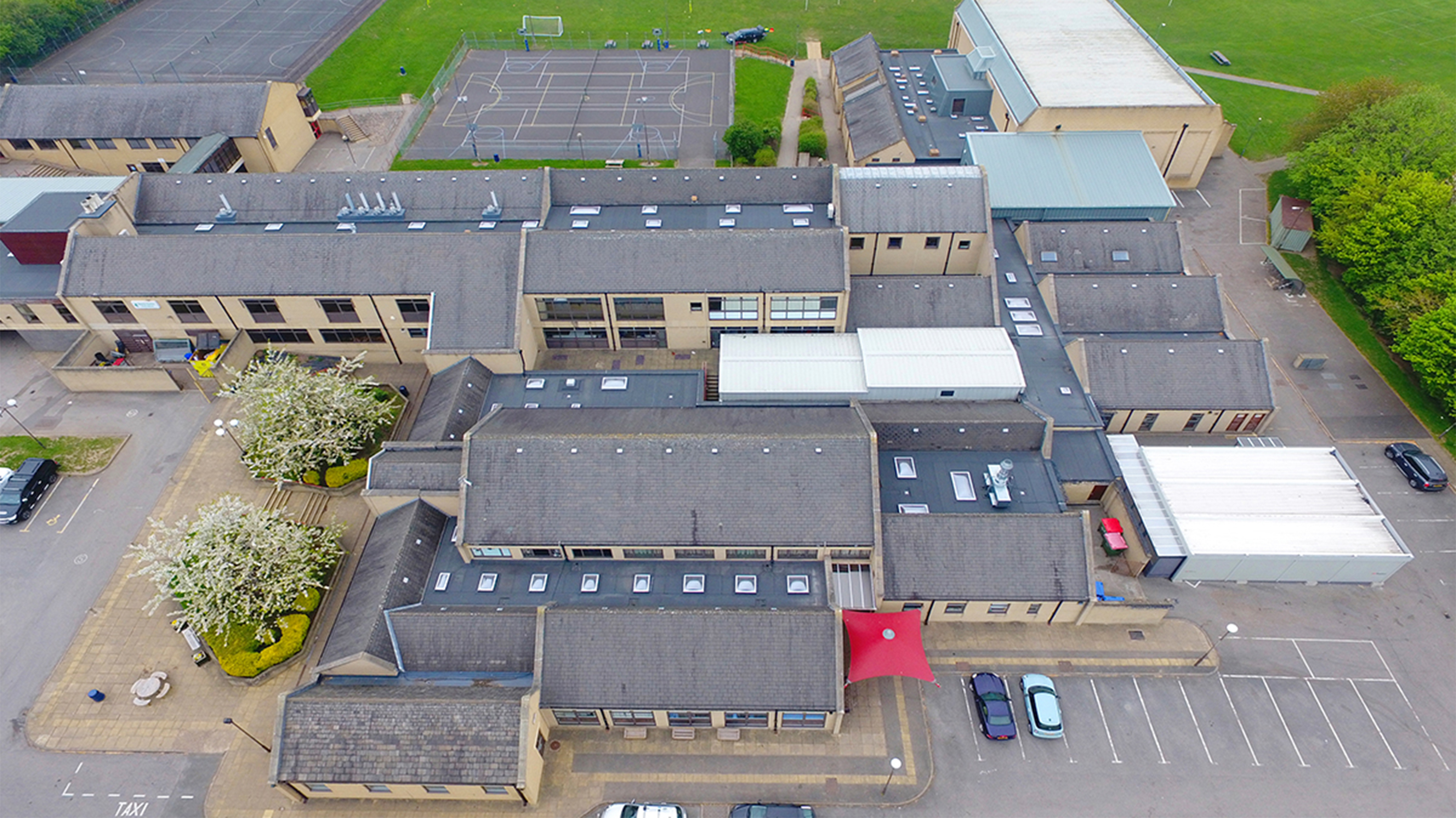 Aerial view of Brighouse High School showing roof with Bauder Total Roof System (BTRS) and BauderDOME rooflights installed