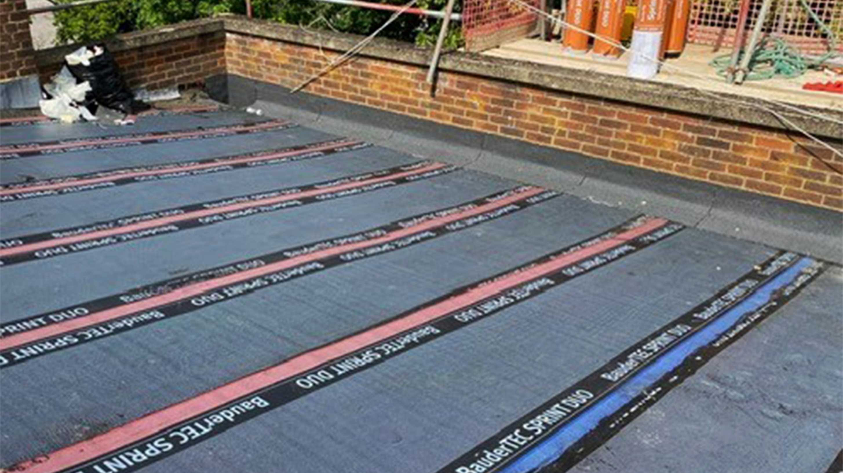 bituminous waterproofing system being installed