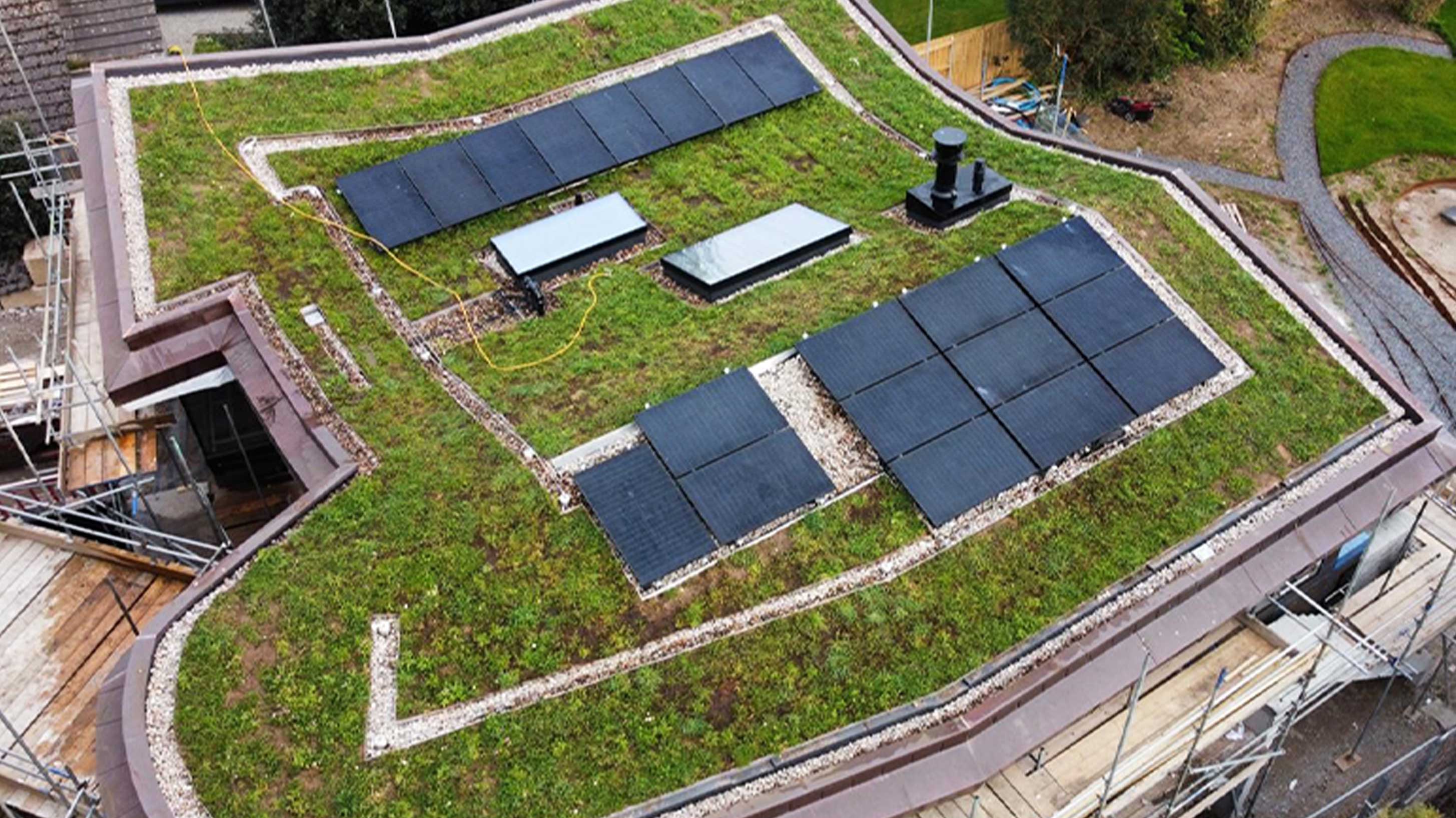 Completed green roof of modern building with solar panels under construction