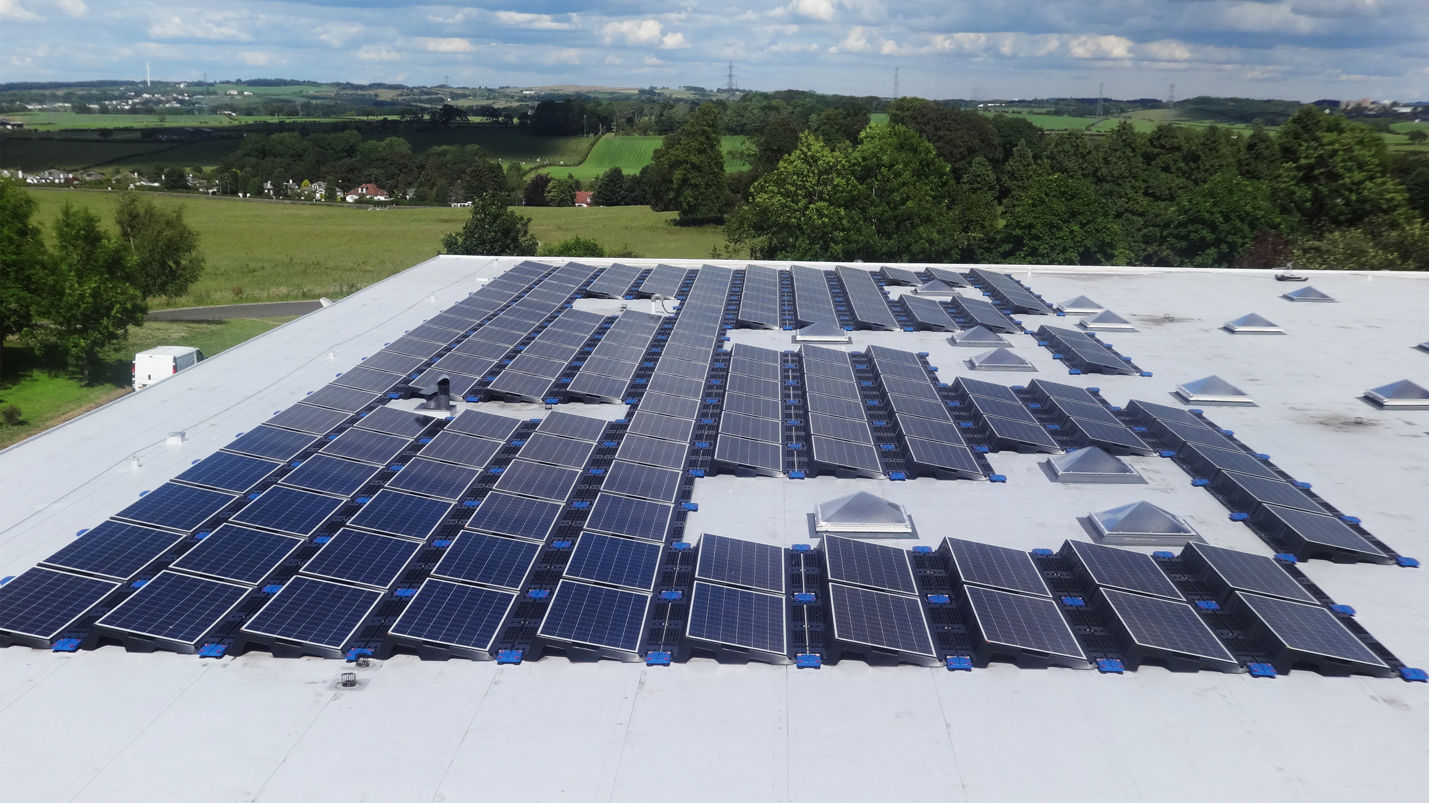 Roof of Linn Products ltd with array of solar panels installed on Bauder Thermofol single ply system