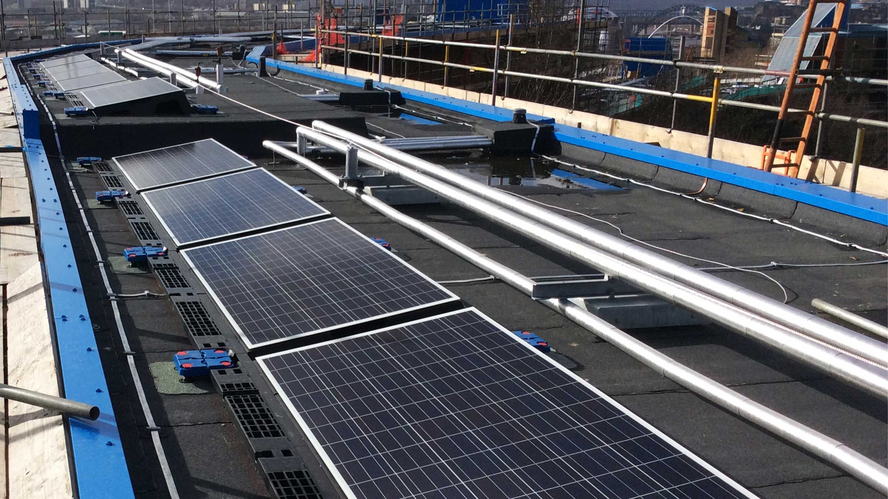 A building in Byker Wall estate, showing roof completed with Bauder Total Roof System  and solar PV