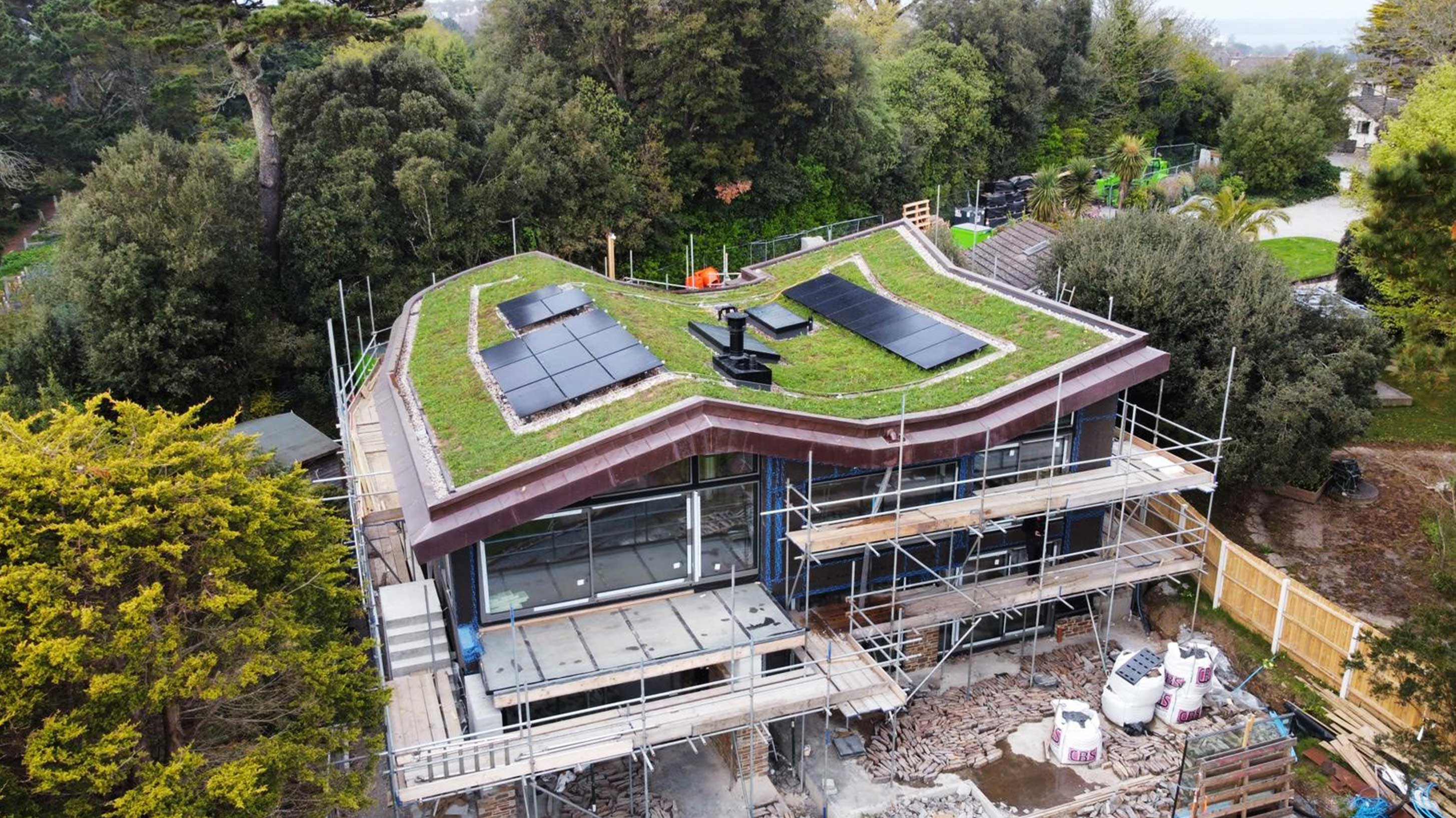 Completed green roof of modern building with solar panels under construction