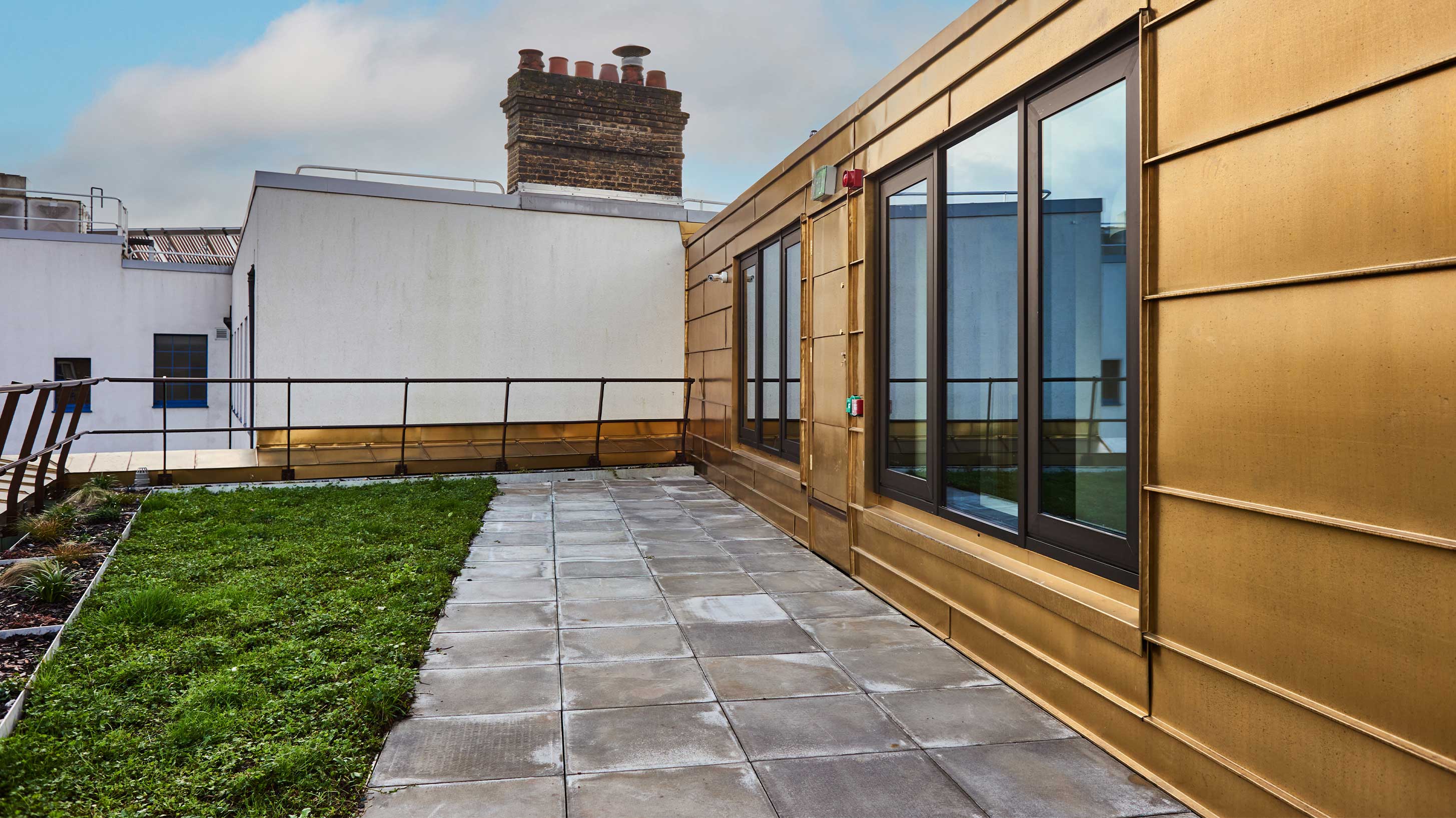 Modern architectural rooftop with decking and wildflower blanket to provide environmental benefits
