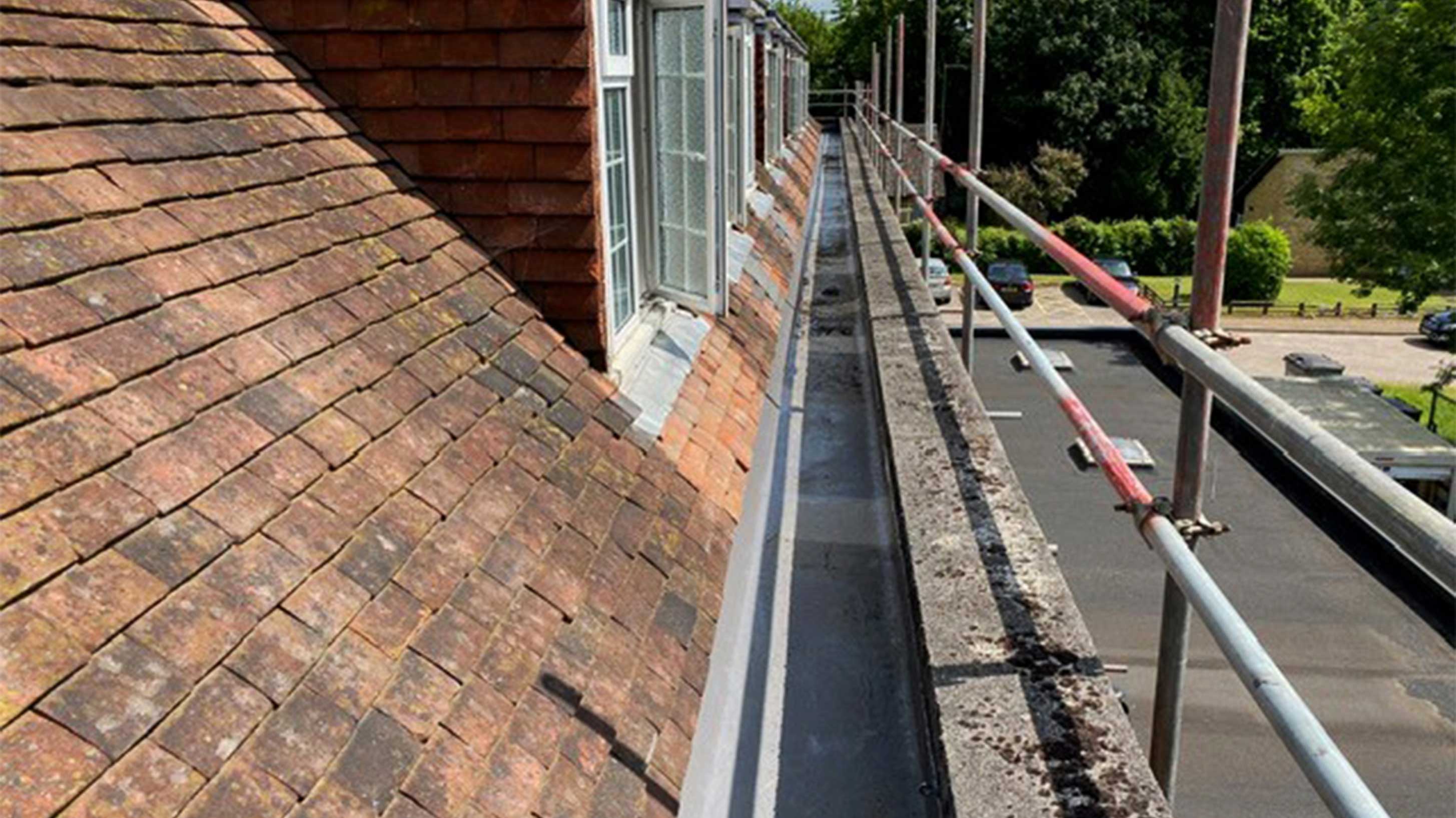 Safety equipment in the form of scaffolding next to pitched roof