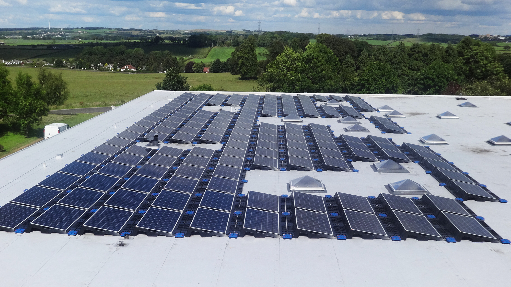 Roof of Linn Products ltd with array of solar panels installed on Bauder Thermofol single ply system