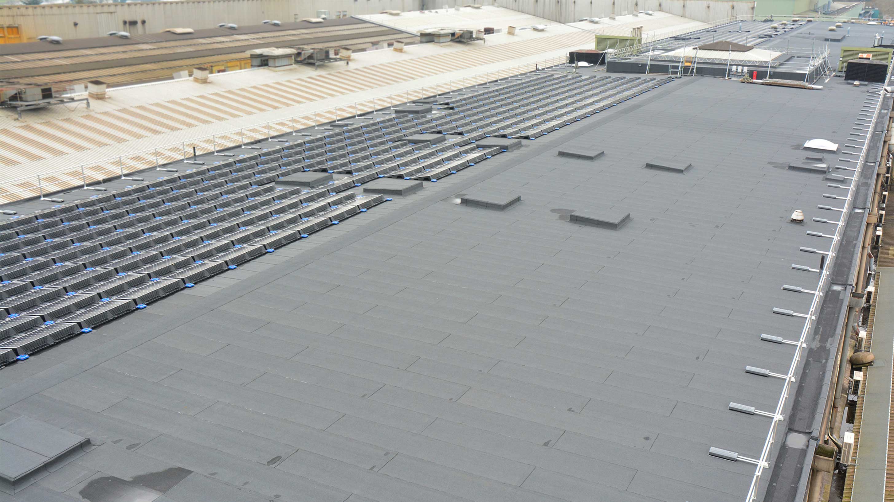Roof of JCB World Headquarters with array of solar panels installed on Bauder Total Roof System