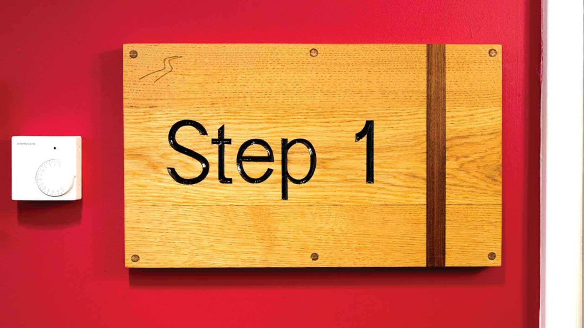 Step 1 writing on golden brown wooden plaque next to thermostat