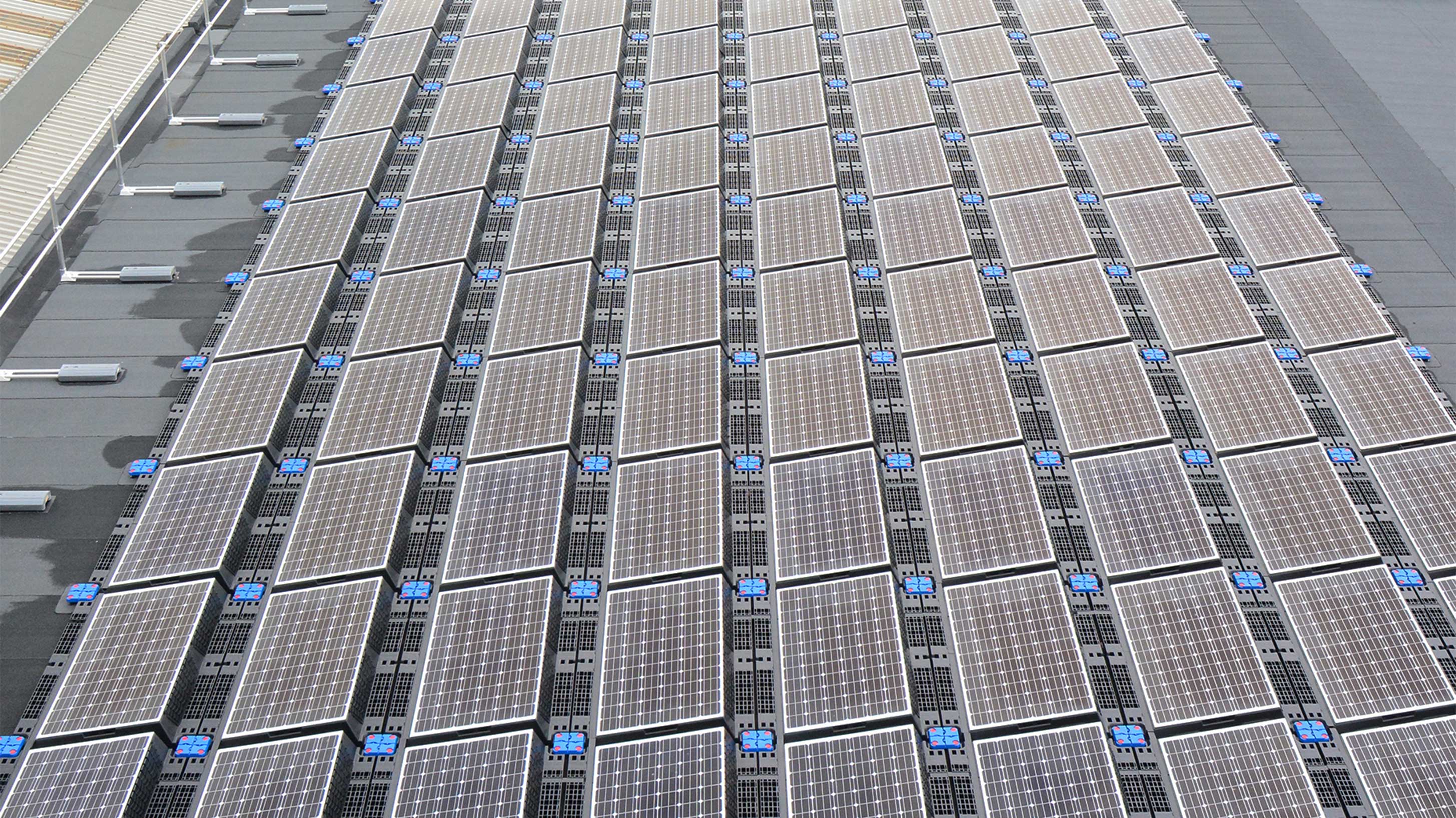 Roof of JCB World Headquarters with array of solar panels installed on Bauder Total Roof System