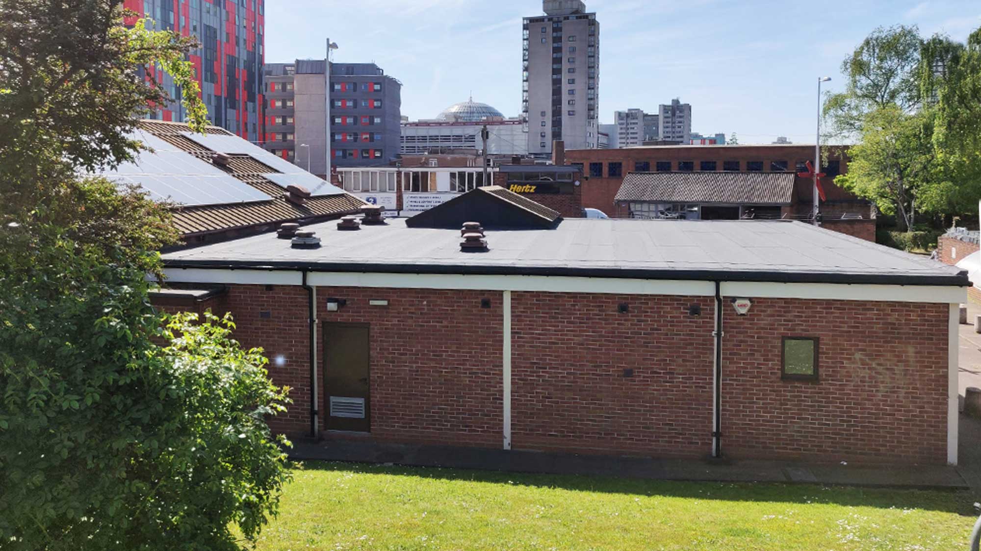 Back of Jesus Centre charity building with waterproofing rooftop