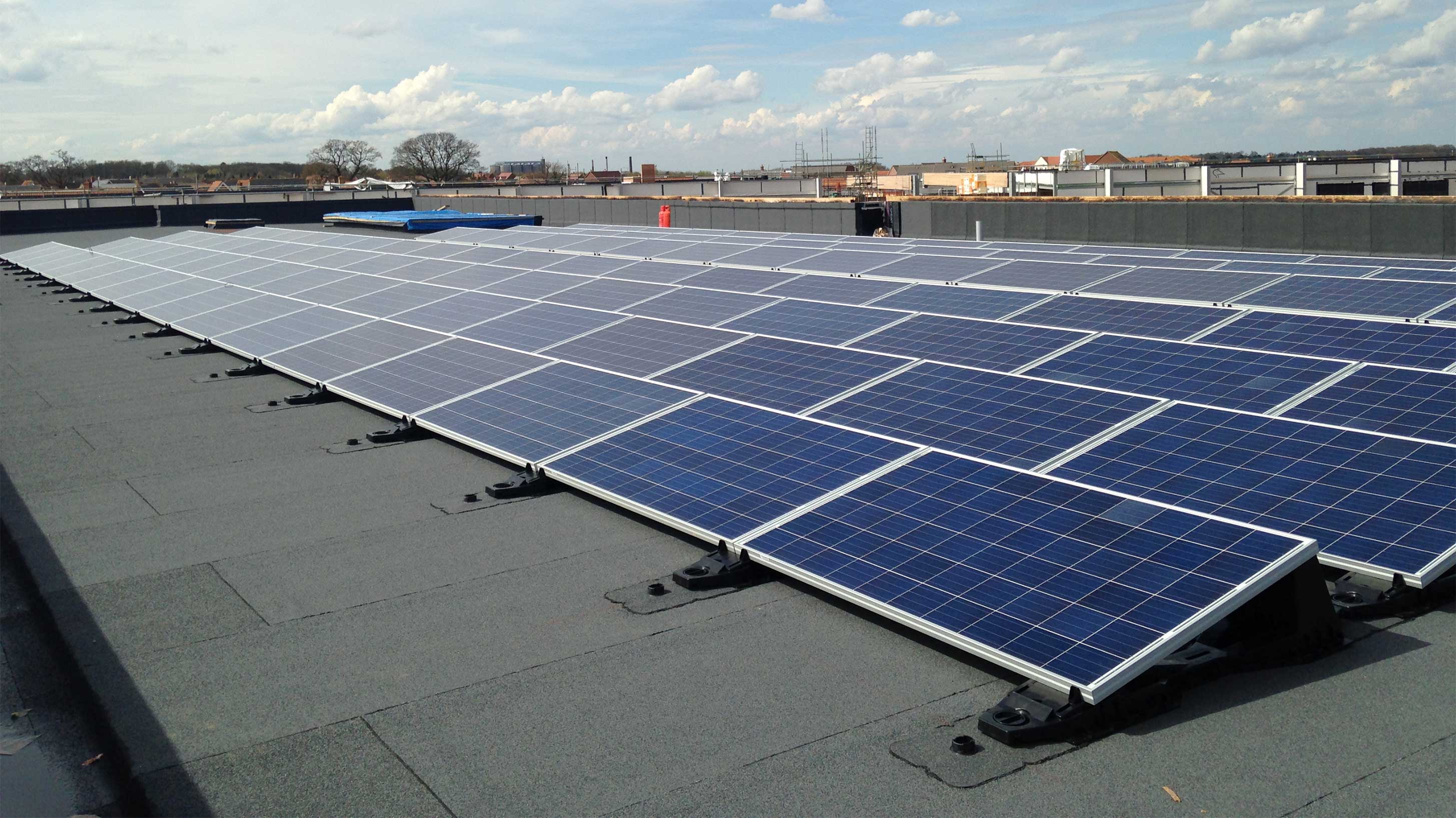 Sybil Andrews Academy rooftop with array of solar PV systems