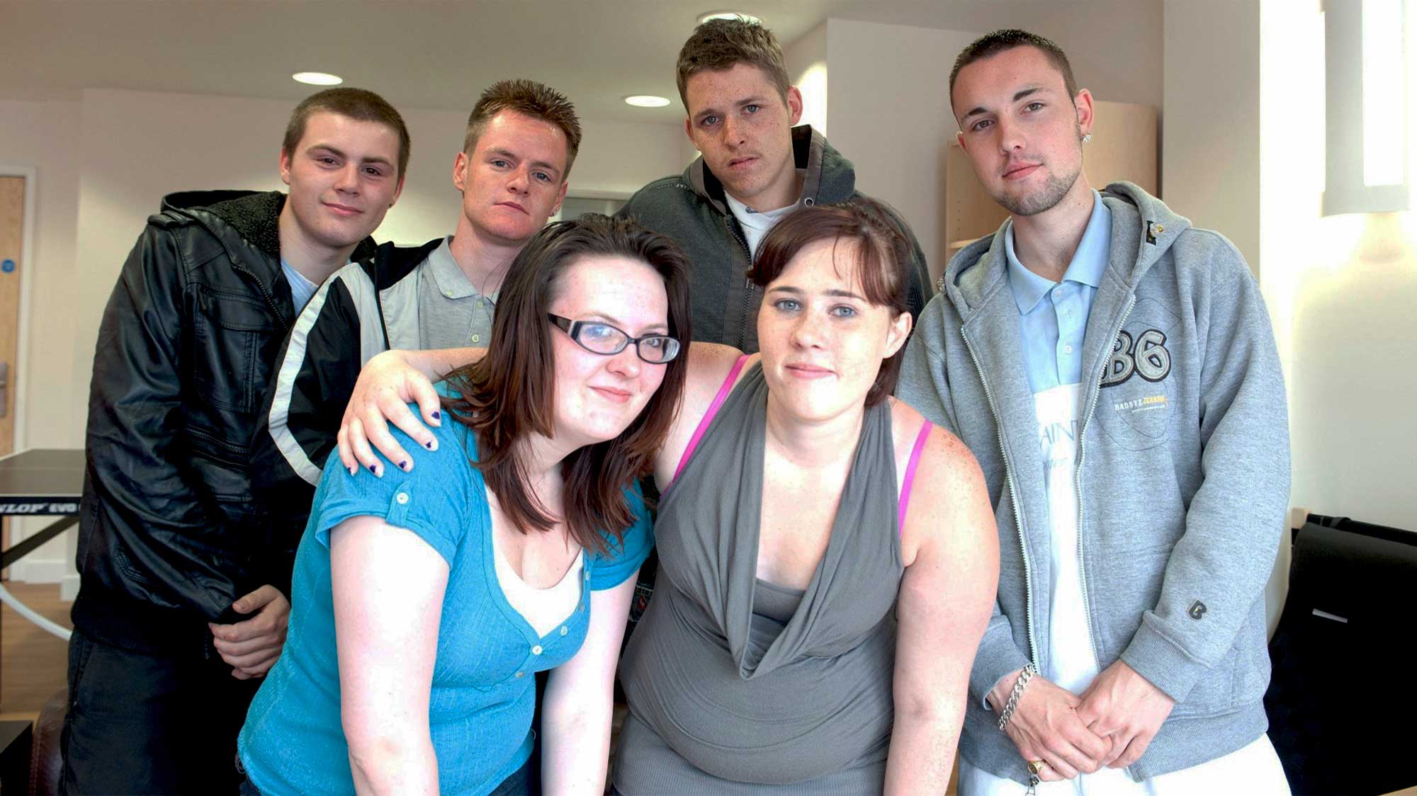 A group of young people standing with eachother