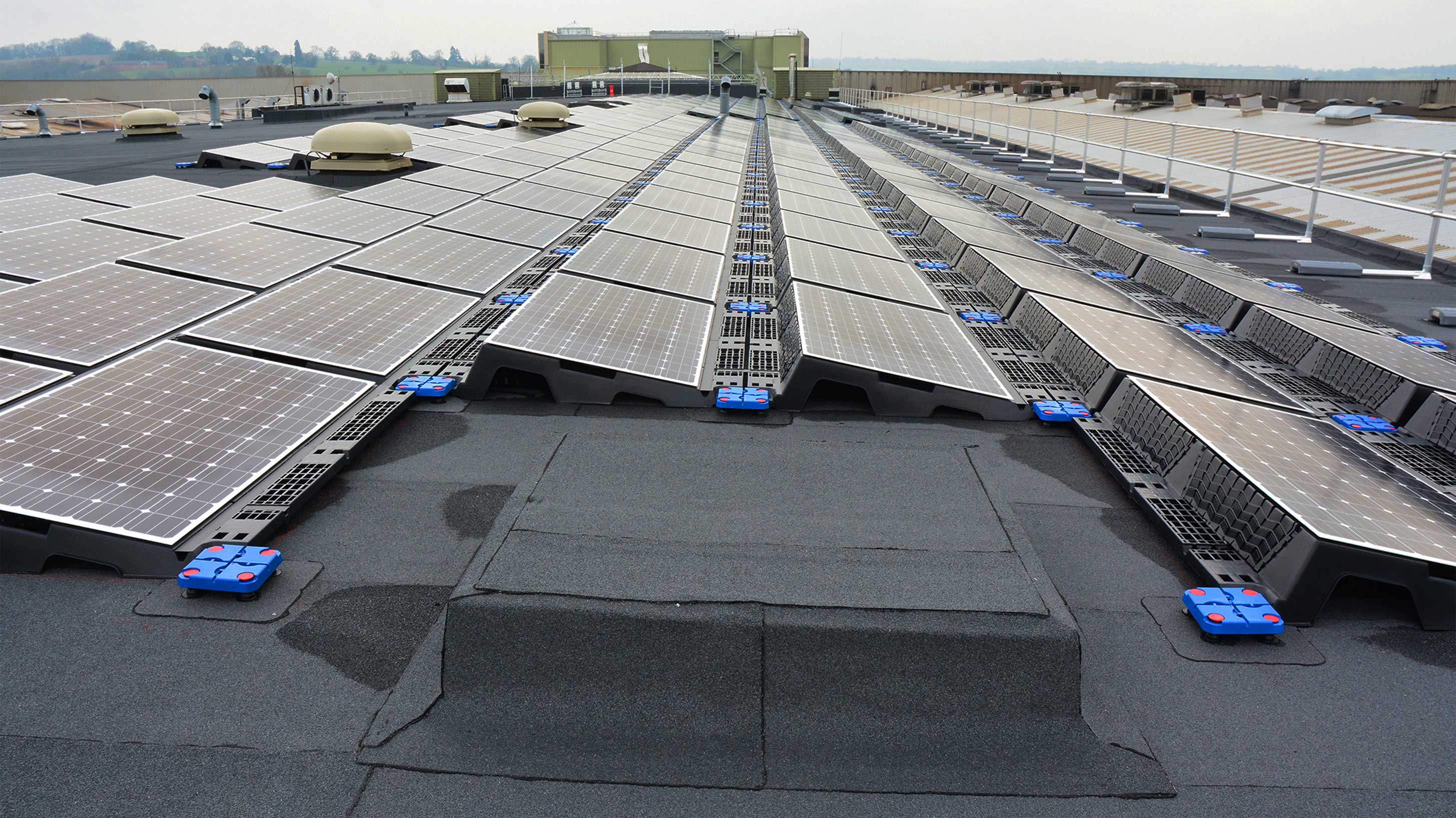 Roof of JCB World Headquarters with array of solar panels installed on Bauder Total Roof System