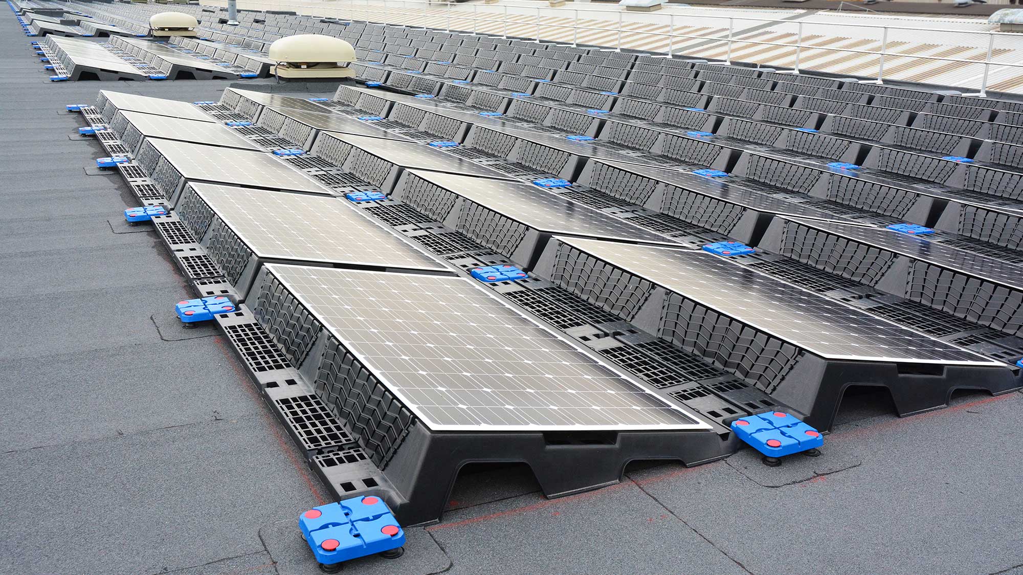 Roof of JCB World Headquarters with array of solar panels installed on Bauder Total Roof System