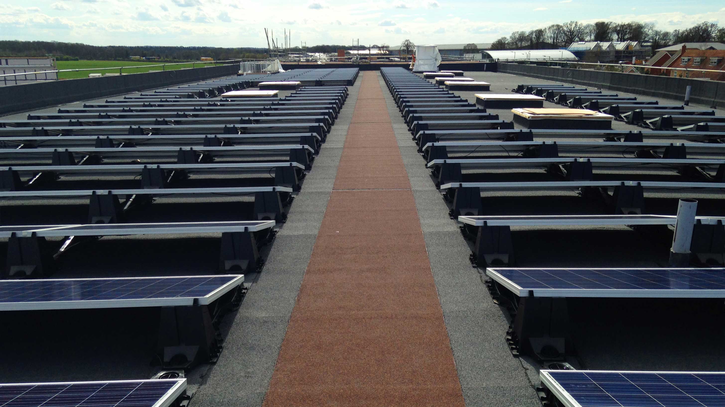 Sybil Andrews Academy rooftop with array of solar PV systems